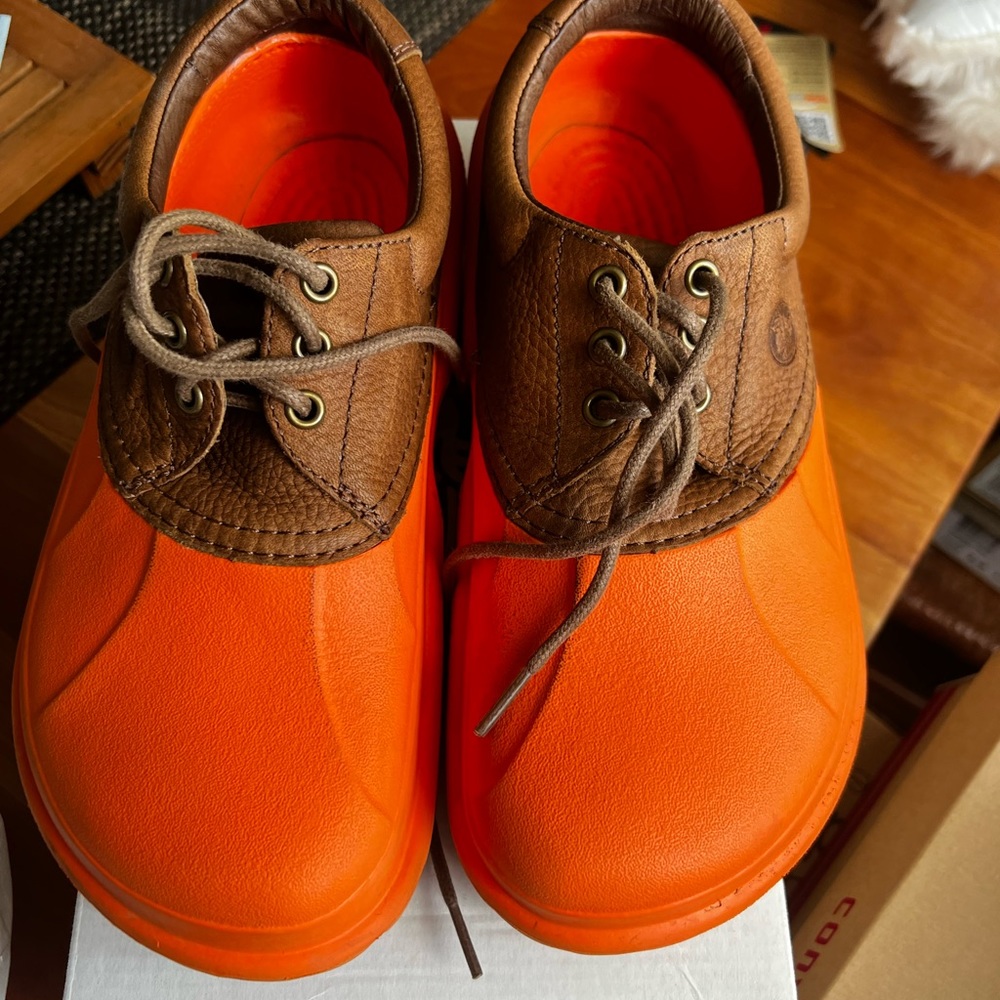 Orange Crocs with leather accent